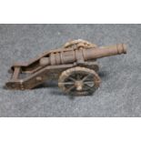 An antique cast iron model of a signal cannon