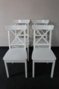 A set of four painted wooden dining room chairs