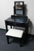 A modern black dressing with mirror and stool