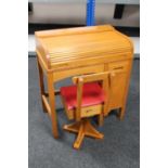 A mid 20th century child's roll top desk and chair