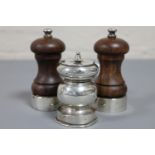 A pair of silver mounted salt and pepper mills together with one other white metal grinder.