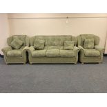 A contemporary three piece lounge suite in light green fabric