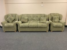 A contemporary three piece lounge suite in light green fabric