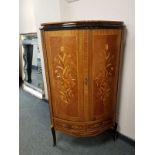 A reproduction bow fronted corner cabinet with inlaid panel doors,