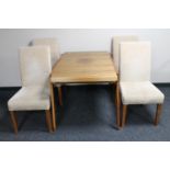 A vintage teak extending dining table and four later dining chairs