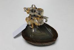 An Italian silver and silver-gilt figure of a knight on horseback, on polished stone base,