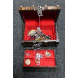 A wooden chest of costume jewellery, dress rings,