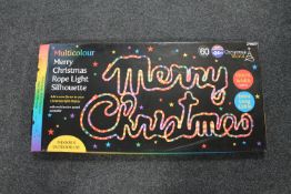 A multi colour "Merry Christmas" rope light silhouette