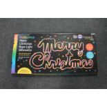 A multi colour "Merry Christmas" rope light silhouette