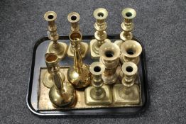 A tray of brass candlesticks