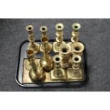 A tray of brass candlesticks