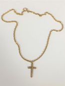 A 9ct gold crucifix on yellow metal chain