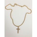 A 9ct gold crucifix on yellow metal chain