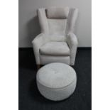 A contemporary suede armchair with oatmeal footstool