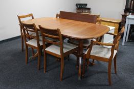 A reproduction twin pedestal table and six chairs by McIntosh