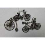 Two miniature silver bicycles and a penny farthing with stand, tallest 4.