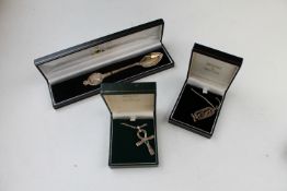 A silver commemorative spoon from The London Mint and two pendants on chains