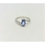 A 14ct white gold sapphire and diamond ring featuring centre oval cut blue sapphire (1.