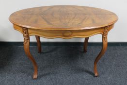 An oval carved walnut dining table