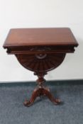 A Regency style mahogany lift top occasional table