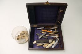 A wooden box of pen knives, pocket knives,