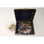 A wooden box of pen knives, pocket knives,