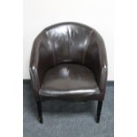 A brown stitched leather tub chair