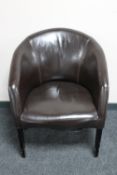A brown stitched leather tub chair