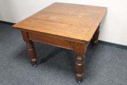 An Edwardian oak dining table