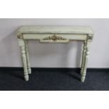 A traditional style cream finished side table