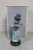 A Lladro figure of a Geisha crouching