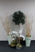 A collection of vases and artificial plants,