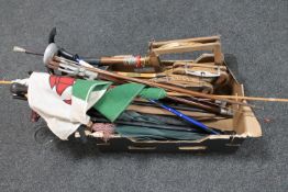 A box of squash rackets, parasols,