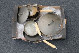 A box of cast iron kitchen ware,