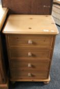 A pine four drawer bedside chest