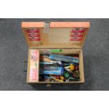 A wooden trunk containing children's toys, die cast vehicles,