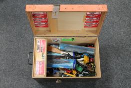 A wooden trunk containing children's toys, die cast vehicles,