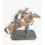 A patinated cast bronze group of jockeys on horseback,
