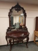 A heavily carved console table on cabriole legs with mirror back,