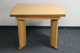 An early 20th century maple pull out dining table