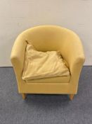 A contemporary armchair in mustard fabric