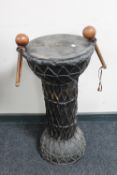 An African drum with beaters