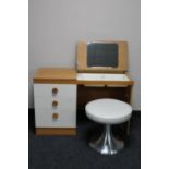 A light oak dressing table with stool