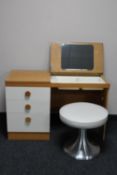 A light oak dressing table with stool