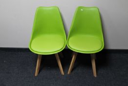 A pair of lime green dining chairs and a painted low coffee table