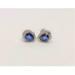 A pair of 14ct white gold sapphire and diamond earrings, featuring two pear cut blue sapphires (1.