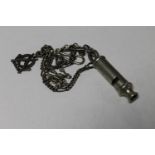 A Metropolitan Police whistle numbered 0333104 on chain,