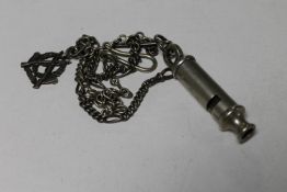 A Metropolitan Police whistle numbered 0333104 on chain,