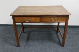 An Edwardian oak two drawer side table