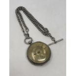 A large antique silver pocket watch on heavy antique silver Albert.